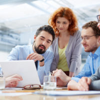 Angle view of a business team discussing the future of their company on the foreground